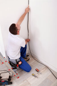 electrician running wire on wall