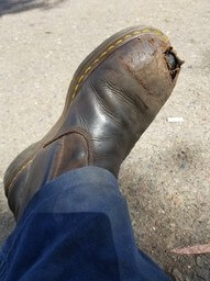 Exposed steel toe cap on work boot