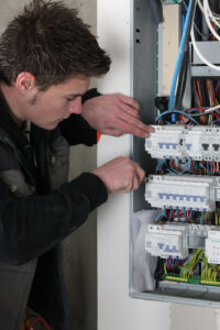 electrician checking a distribution board
